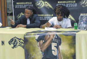 2 football standouts sign scholarships