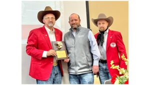 PHOTO BY MARÍA CAMP - FC Cattlemen president, Michael Pounders (left) and vice-president, Caleb Beason (right) present Marty Graham with the Cattleman of the Year award.  